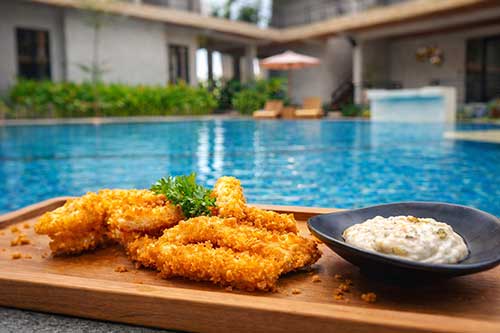 Food served by the pool at Bella Vida Resort